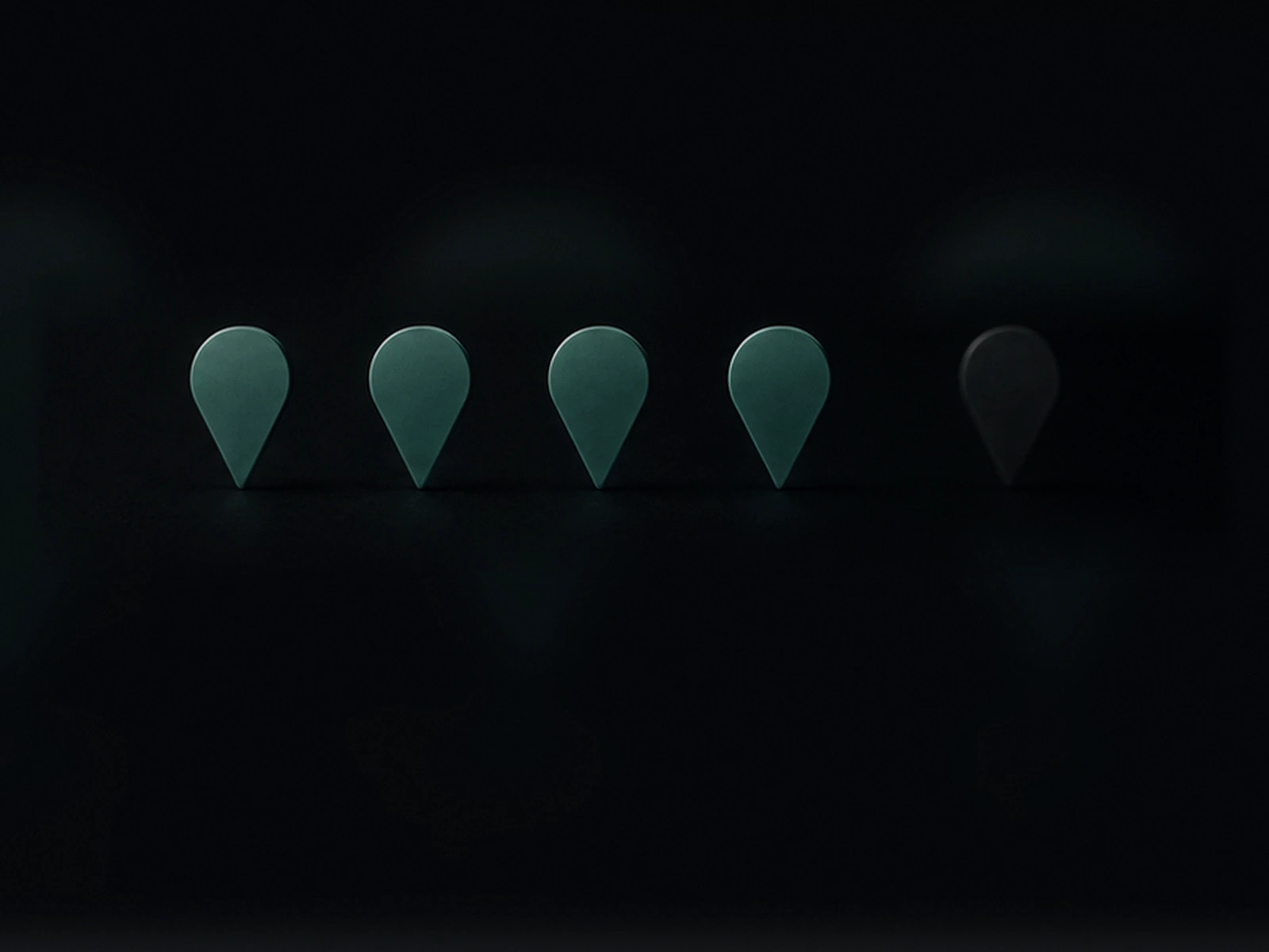 Five markers on a dark map: four are lit and in focus, the fifth is unlit and set apart.